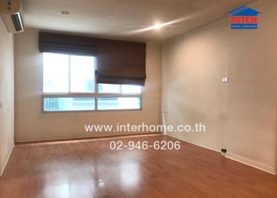 Empty living room with wooden flooring and large window