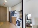 Modern kitchen with integrated washing machine and living space