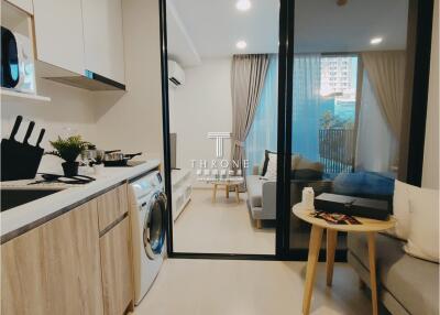 Living area with kitchenette and seating