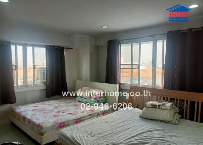 Bedroom with two beds and ample natural light