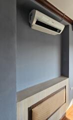 Wall with air conditioning unit and decorative panel