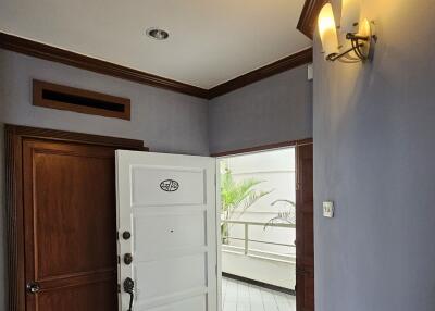 Well-lit entryway with wooden and white doors