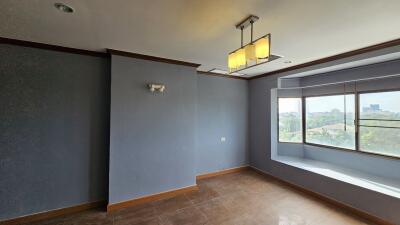 Unfurnished living room with large window and modern lighting