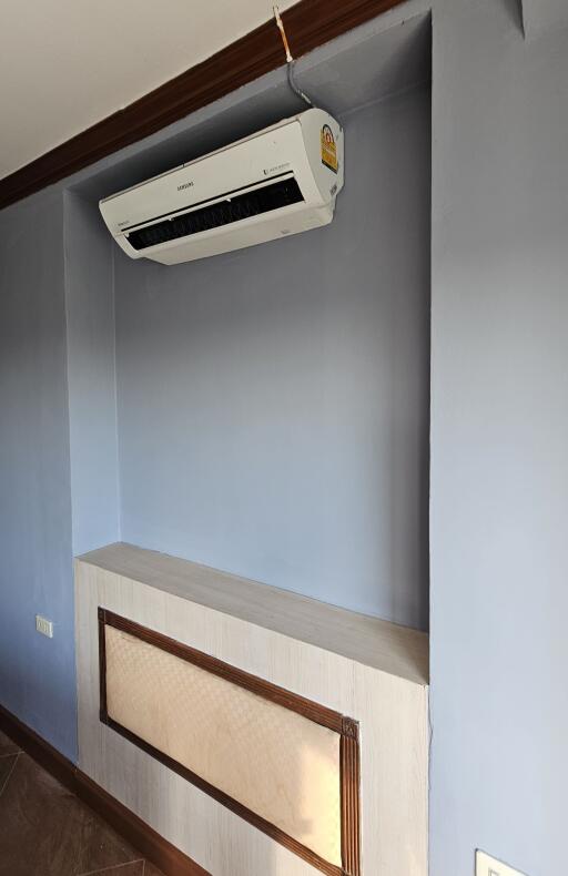 Wall-mounted air conditioner in a room