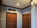 Photo of a residential entryway with wooden doors and tiled floor