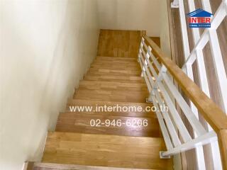 Wooden stairs with white railings