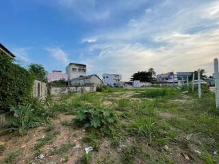 Empty lot with surrounding buildings and vegetation