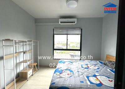 Bedroom with a window, air conditioning, bed with cartoon bedding, and bookshelf