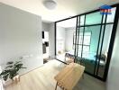 Modern studio apartment with a glass partition and wooden furniture