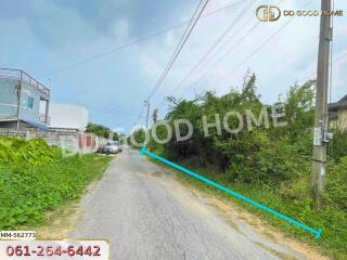 Photo of a road leading to property with greenery and houses