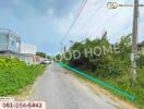 Photo of a road leading to property with greenery and houses