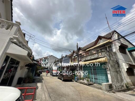 Street view with multiple houses and interhome real estate banner