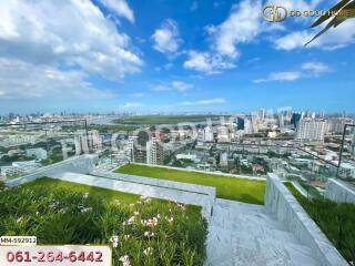 High-rise building with a view of the cityscape and garden