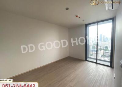 Unfurnished bedroom with large window and city view