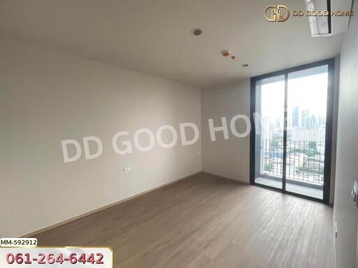 Unfurnished bedroom with large window and city view