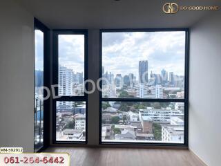 Living room with a large window offering a city view