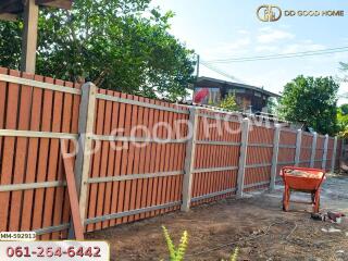 Wooden fence with a house in the background