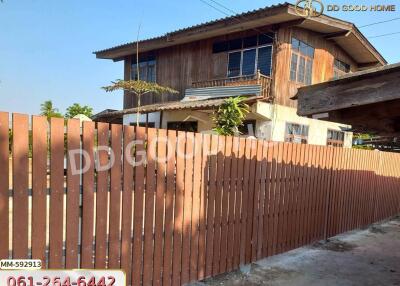 Two-story house with wooden fence