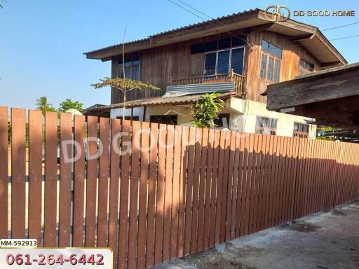 Two-story house with wooden fence