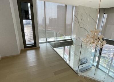 Modern living room with glass railing and city view