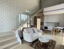 Modern duplex living area with open kitchen and staircase