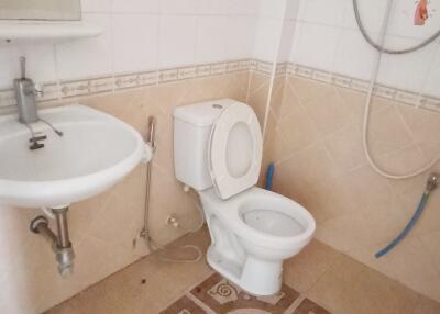 Well-maintained bathroom with sink, toilet, and water heater