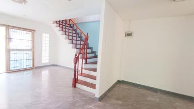 Modern living space with staircase and large windows