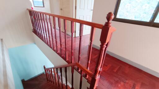 Indoor staircase with wooden handrails and steps