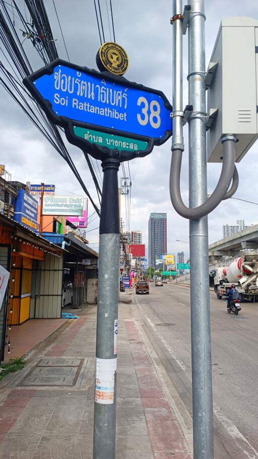 Street view of Soi Rattanathibet 38 with visible sidewalk and surroundings