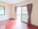 Bright bedroom with wooden floor and large window