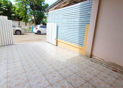 Gated outdoor area with tiled flooring.