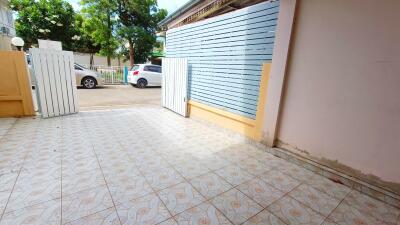 Gated outdoor area with tiled flooring.