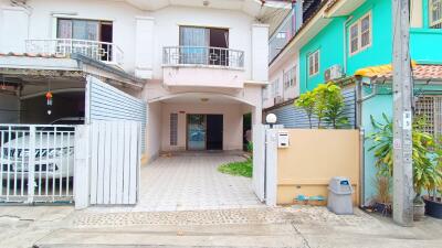 Front view of a residential building with garage and gated entrance