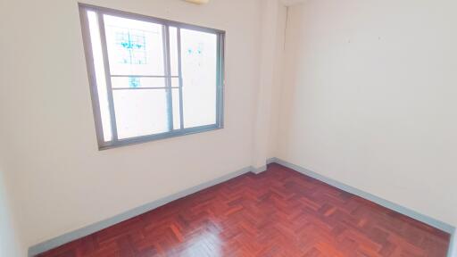 empty bedroom with wooden floor and window