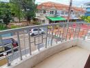 View of the balcony and street from the property