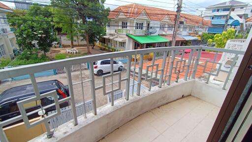 View of the balcony and street from the property