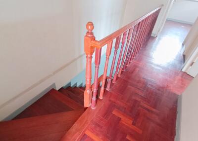 Wooden stairs and landing with railing