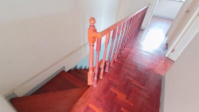 Wooden stairs and landing with railing