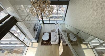 Modern living room with large windows and chandelier