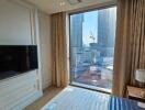 Modern bedroom with a large window and city view