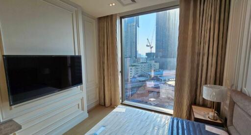 Modern bedroom with a large window and city view