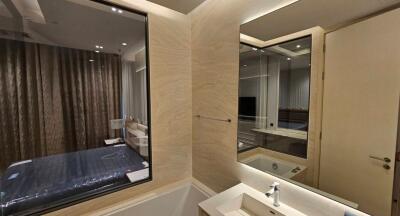 Modern bathroom interior with view into bedroom