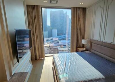 Modern bedroom with a large window and city view