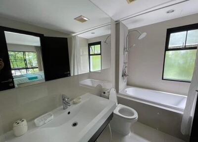Modern bathroom with a bathtub, shower, sink, and toilet
