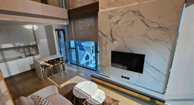 Modern Living Room with Marble Accent Wall and Large Windows