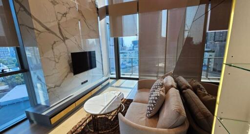 Modern living room with marble accent wall and city view