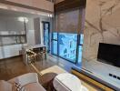 Modern living space with kitchen and marble TV wall