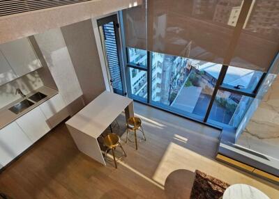 Modern kitchen with island and bar stools in well-lit apartment