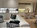 Modern open plan living room and kitchen with white furniture and wooden flooring