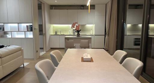 Modern kitchen and dining area with white cabinets and table